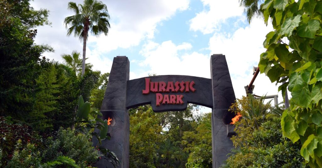 A lush, iconic Jurassic Park entrance in Orlando's Universal Studios.
